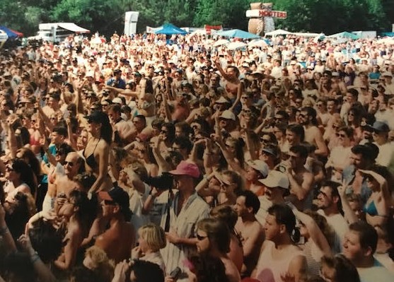 A large crowd of people in white shirts and hats.