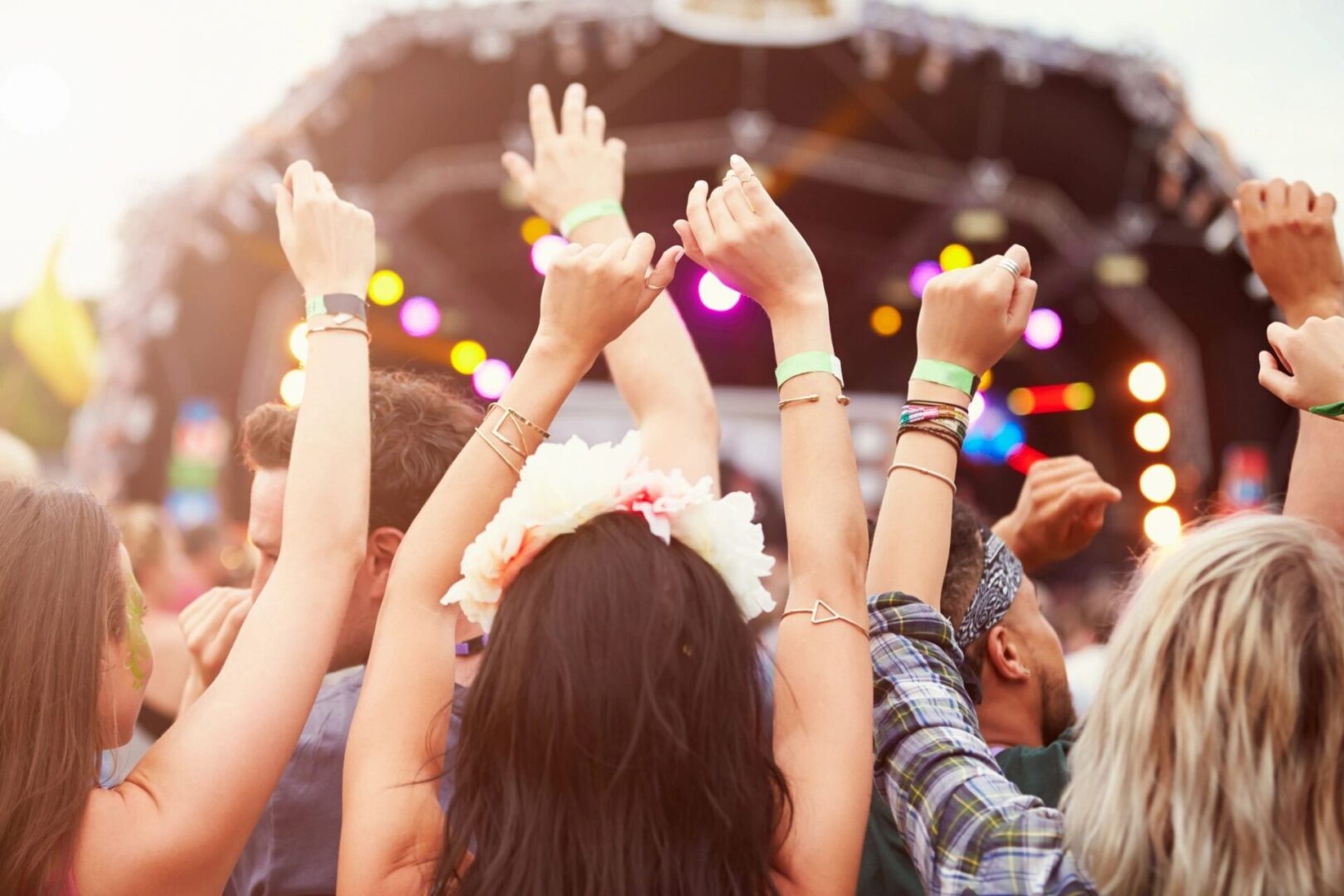 A group of people with their hands up at an event.